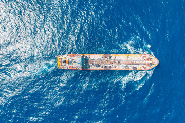 Oil chemical tanker sails blue sea. Aerial top view