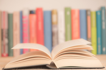 Open books close-up in library, toned pastel color background