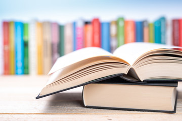 Close-up open book with library bookshelf