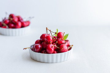 fresh cherries in a bowl isolated on white