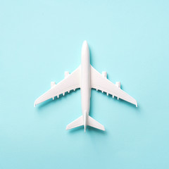 Travel, vacation concept. White model airplane on pastel blue color background with copy space. Top view. Flat lay. Minimal style design. Square crop