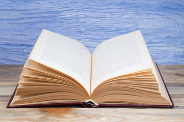 open book on the blue background. Back to school. Education. Copy space for text.
