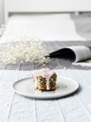 Sweet cake with poppy seeds and yogurt on a light bed.