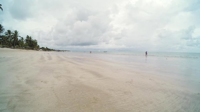 Timelapse video of a cloudy day at the beach. People enjoying the day at Ponta de Campina beach - Cabedelo PB, Brazil.
