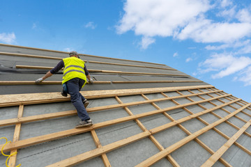 Building construction process of new wooden roof on wood frame house