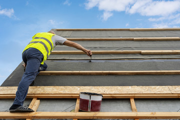 Building construction process of new wooden roof on wood frame house