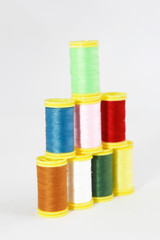 colorful threads for sewing or embroidery on a white background