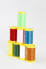 colorful threads for sewing or embroidery on a white background