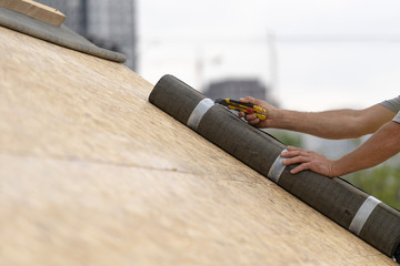 Building construction process of new wooden roof on wood frame house