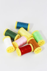 Fototapeta na wymiar colorful threads for sewing or embroidery on a white background