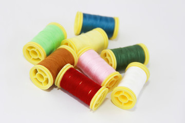 colorful threads for sewing or embroidery on a white background
