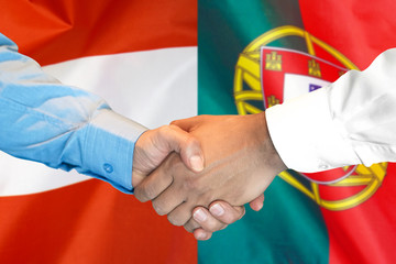 Business handshake on the background of two flags. Men handshake on the background of the Portugal and Austria flag. Support concept