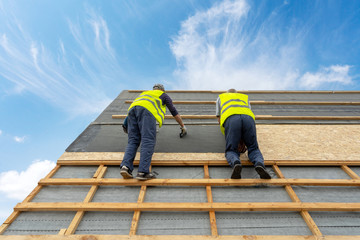 Building construction process of new wooden roof on wood frame house