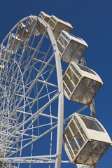 Ferris wheel against the blue sky amusement Park.