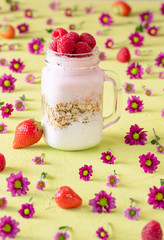 Muesli and raspberry yogurt in a jar
