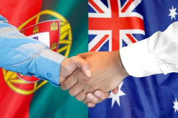 Business handshake on the background of two flags. Men handshake on the background of the Portugal and Ukraine flag. Support concept