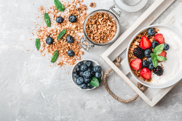 Obraz na płótnie Canvas Healthy breakfast with granola, yogurt, fruits, berries on white background.