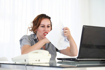 Office worker woman reading negative news in letter. Shocked beauty girl business manager received layoff message letter from company feeling surprised. An agitated girl without joy.