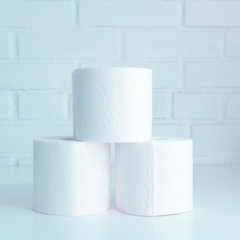 Stack of toilet paper rolls. Concept of body care, disposables, paper hygienic products. Blue.