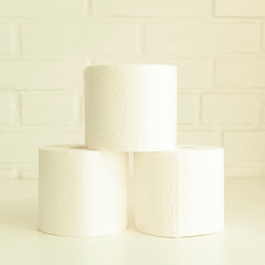 Stack of toilet paper rolls. Concept of body care, disposables, paper hygienic products.