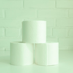 Stack of toilet paper rolls. Concept of body care, disposables, paper hygienic products.