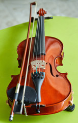 Violin on a green background, close-up