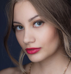 Beautiful ,young blonde with bright red lips and expressive eyes in a black jumpsuit. Beauty portrait of a girl. Emotional and bright appearance. Fashion portrait of a woman.