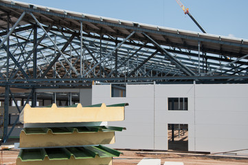 Naklejka premium Thermal insulation of the metal frame of the building with insulation panels. The process of installing insulation panels. Modern building insulation.