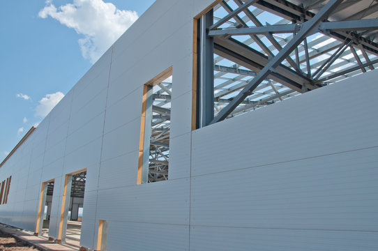 Sandwich panels at the construction site. Material for warming the walls of the building. Technologies in construction. An alternative to a brick building.