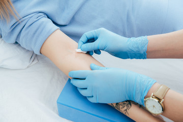 cropped view of doctor preparing donor for blood donation