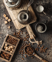 Coffee on wooden board with coffee beans on dark textured background. Top view with copy space. Background with free text space.