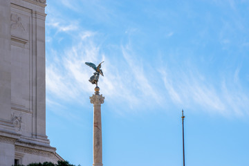 Fototapeta na wymiar Winged woman statue in front of Altare della Patria, Piazza Venezia, Rome Italy