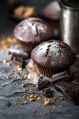 Muffin with coffee on dark textured background.