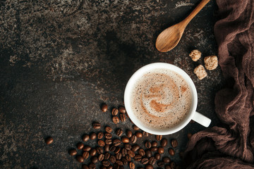 Coffee board with coffee beans on dark textured background.