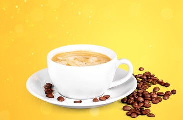 Coffee cup and coffee beans on wooden background