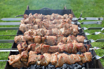 Shashlik pork on skewers.  Meat roasted on an open fire on the grill. Nature. Selective focus. 