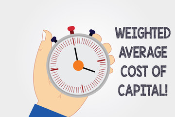 Handwriting text writing Weighted Average Cost Of Capital. Concept meaning Wacc financial business indicators Hu analysis Hand Holding Mechanical Stop Watch Timer with Start Stop Button
