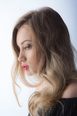 Obraz premium Beautiful ,young blonde with bright red lips and expressive eyes in a black jumpsuit. Beauty portrait of a girl. Emotional and bright appearance. Fashion portrait of a woman.