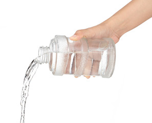Pouring water from bottle isolated on white background