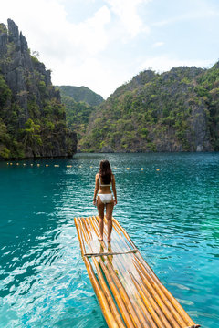 Woman sun bathing on the sea shore, Philippines