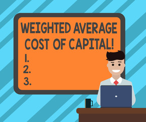 Text sign showing Weighted Average Cost Of Capital. Conceptual photo Wacc financial business indicators Blank Bordered Board behind Man Sitting Smiling with Laptop Mug on Desk