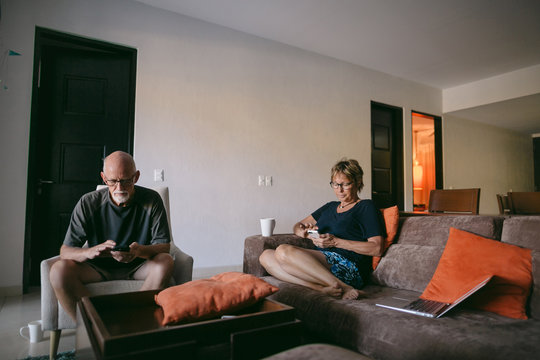 Couple using technolgy at home