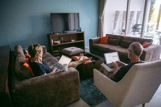Couple using technolgy at home
