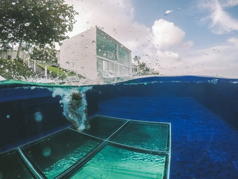 Split shot of boy jumping into a pool at a luxurious villa