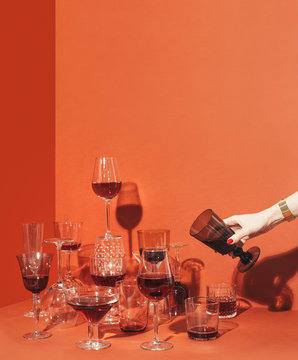 Woman's Hand Pouring Drink Into Glass