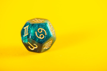 Astrology Dice with zodiac symbol of Cancer Jun 21 - Jul 22 on Yellow Background