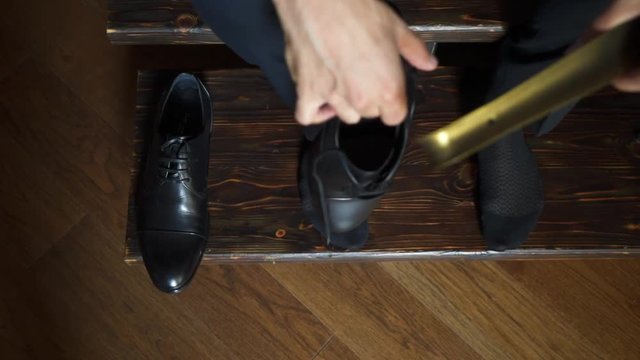 Man put on black shoes