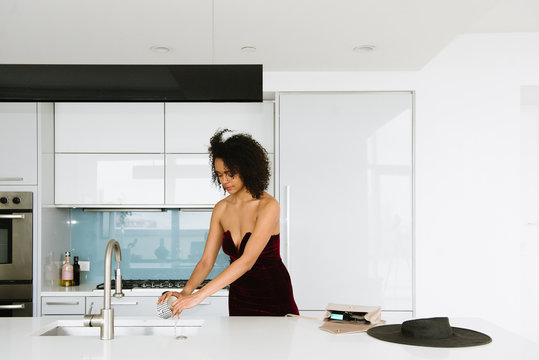 Woman cleaning up in kitchen