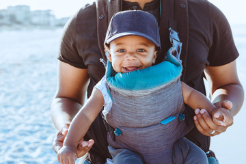 Black father and son walking on the beach