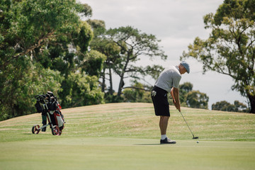 Senior man playing golf on the public golf course